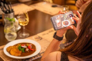 person_taking_a_photo_of_food
