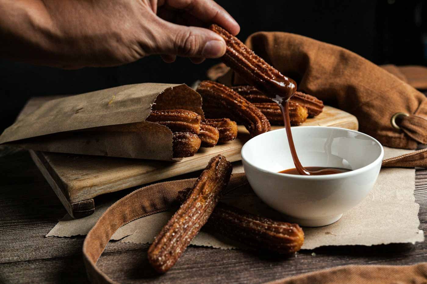 Person_dipping_churros_into_sauce_Barcelona